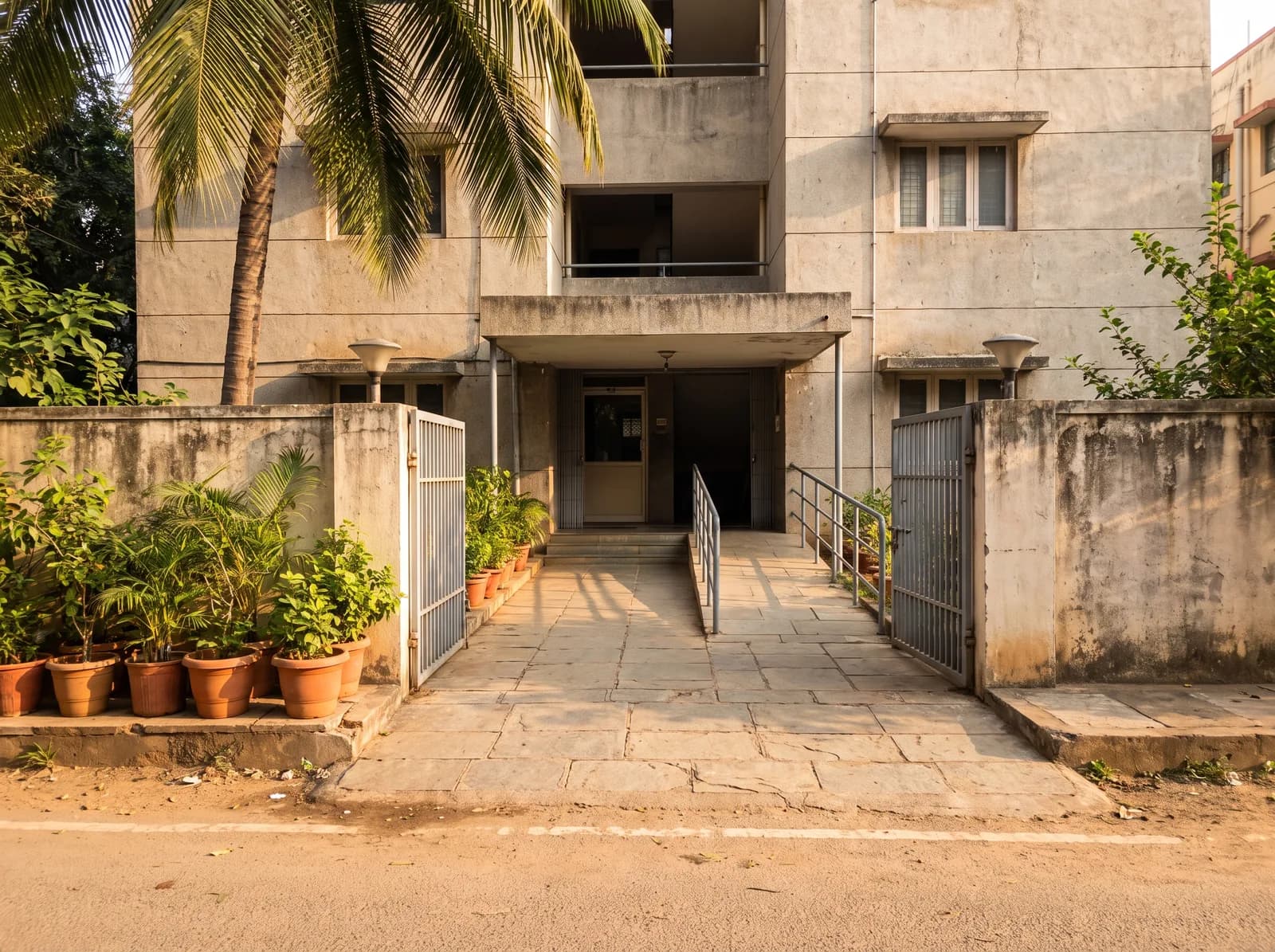 Street to the lobby door. The ramp runs beside the steps.